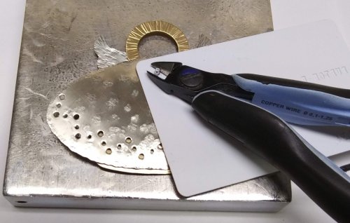 Judy Larson's Angel Ornament  - , Holiday Designs, Cutting, Cutting Tool, Cutters, Forging, Forging Jewelry, Jewelry Forging, How To Punch Holes, Hole Punching, Punch A Hole, Stamping, Stamps, Texturing, Place the hole in the credit card over the rivet.